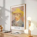 A print of Van Gogh's Self-Portrait with a Straw Hat (1887) hanging in a modern, light-filled living room over a blonde wood media console.